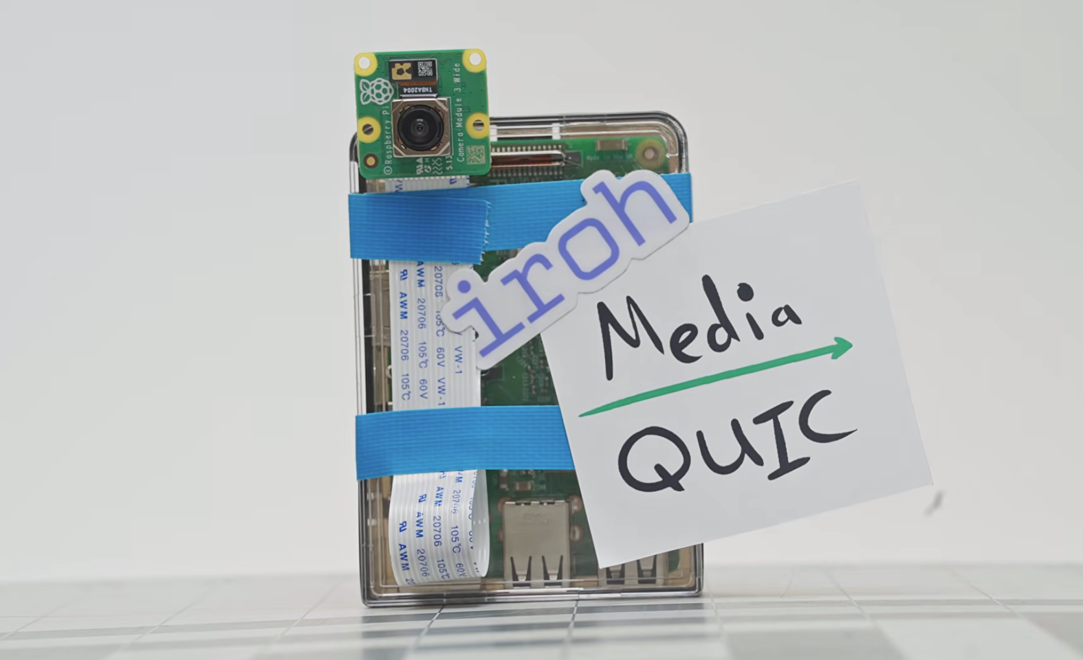 A Raspberry Pi with a camera taped to it, next to a security camera